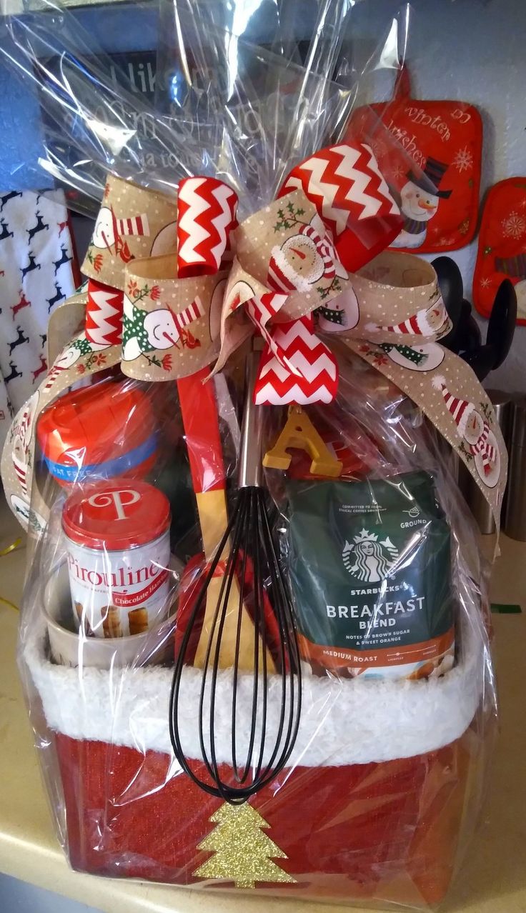 a basket filled with holiday food and baking utensils on top of a counter