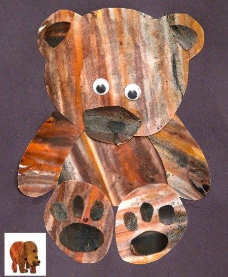 a brown bear made out of wood sitting on top of a purple background with the words, brown bear inspired bear craft