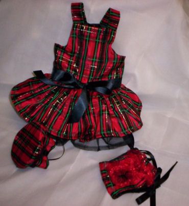 a red and black plaid dress with matching headband, mittens and booties