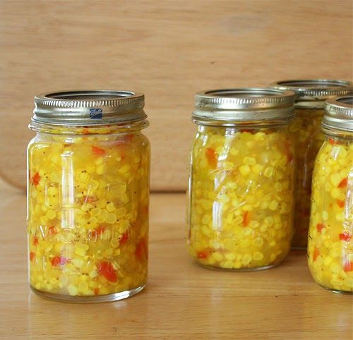 three jars filled with yellow and red food