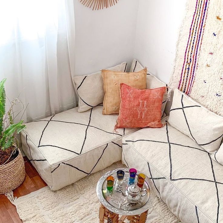 a living room filled with furniture and a potted plant on top of a table