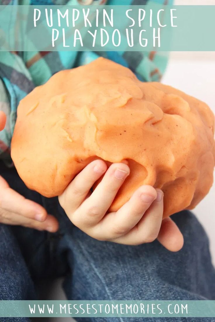 a child holding a pumpkin spice playdough with text overlay that says pumpkin spice playdough