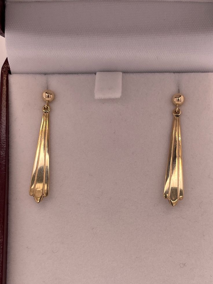 Solid 14kt yellow gold earrings are very elegantly shaped and are a classic look that can be worn daily. Measuring 35mm top to bottom and 5.8mm wide at the widest part (at bottom) and have pierced friction posts. 2.2g. Money back guarantee within 14days. Buyer pays return shipping and must be returned in original condition with box and no alterations. Classic Yellow Gold Earrings For Formal Occasions, Elegant Stamped 14k Gold Dangle Earrings, 14k Gold Drop Earrings For Evening, Formal 14k Gold Earrings For Pierced Ears, Formal 14k Gold Earrings, Classic 14k Gold Earrings For Formal Occasions, Classic Linear Earrings For Evening, 14k Gold Stamped Drop Earrings, Classic Dangle Linear Earrings