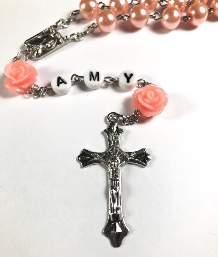 Hello and welcome. This rosary can be personalized with a baby's name or initial letters, ideal count of letters is 3 to 5. I recommend to choose a short version of baby's name for better look. Necklace measures 21 inches, it can grow with baby or can be put away as a keepsake memory for later. This will make a perfect baptism/ christening gift! Spiritual Pink Jewelry For Birthday, Adjustable Pink Rosary Bracelet For First Communion, Pink Beaded Spiritual Rosary, Personalized Rosary Bracelet For Birthday And Mother's Day, Personalized Pink Rosary Bracelet For Baptism, Handmade Rosary With Round Beads For Baptism, Customizable Pink Jewelry For Personalized Gift, Personalized Cross Rosary Bracelet For Baptism, Adjustable Rose Gold Rosary As Gift