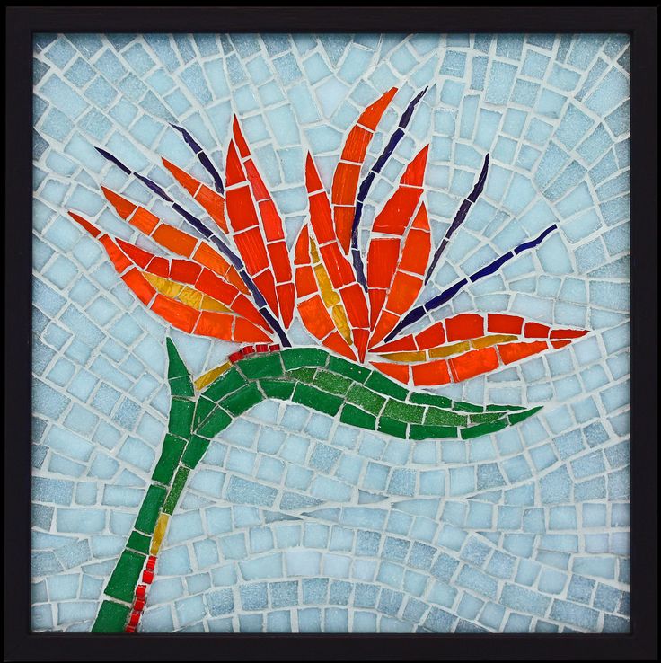 an orange flower on a mosaic tile background