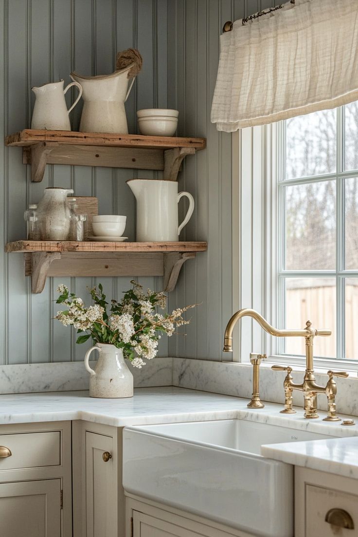 a white kitchen sink sitting under a window next to a counter top with dishes on it