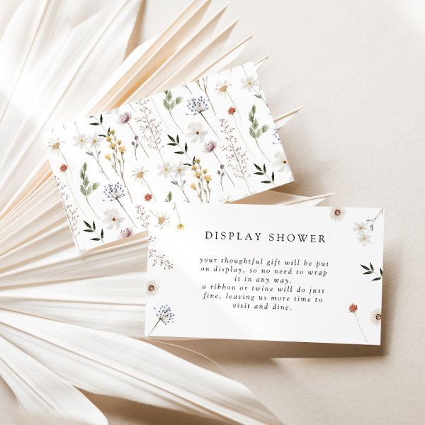 two cards with flowers on them sitting next to each other