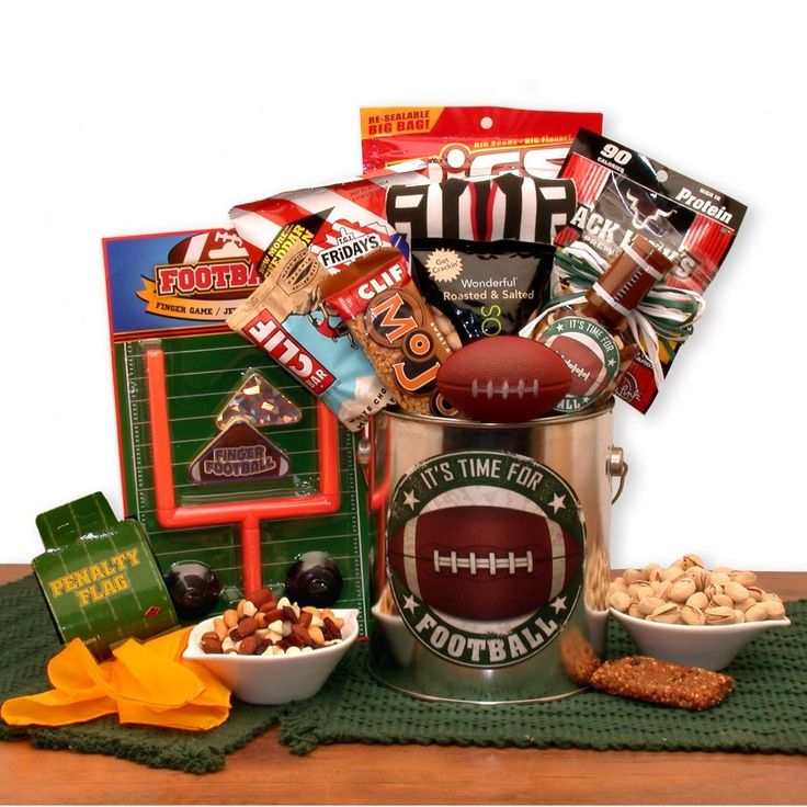 It's Time for football! Send your favorite football fan a real treat. Filled with fanfare to last the entire game and even a game to play during halftime. Every football fan will love the roasted and salted pistachios, the delicious cheddar bacon chips, snack mix and more. The It's Football Time Gift Pail includes: Football pail, Relaxable mini football, It's time for football snack mix, football noise maker, Jack Links Jerky, TGI Fridays cheddar bacon chips, Cliff peanut butter energy bar, Cliff Mojo trail mix bar, referee bottle koozie, sunflower seeds, roasted and salted pistachios, football penalty foul flag, and tabletop football game. Disclaimer: *All contents subject to change based on availability at time of purchase. Any and all substitutions will maintain the monetary value of th Sports Gift Basket, Football Gift Baskets, Bacon Chips, Beer Nuts, Snack Gift Baskets, Pinterest Valentines, Roses Valentine, Football Lover Gifts, Gift Baskets For Him