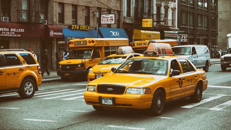 taxi cabs and other vehicles on a city street