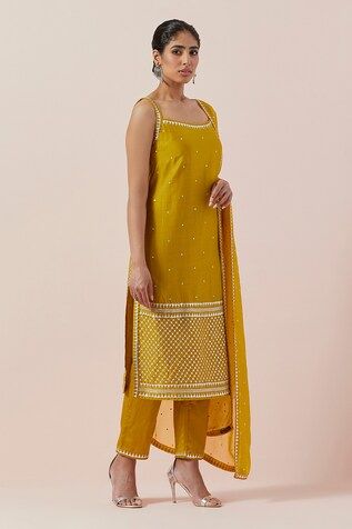 Mustard yellow kurta with aari, sequin and zari work in chanderi base. Paired with a cotton pant and silk organza dupatta with silver and gold hand embroidery. - Aza Fashions Designer Yellow Unstitched Suit With Mirror Work, Designer Unstitched Yellow Suit With Mirror Work, Yellow Sleeveless Set With Dupatta, Yellow Fitted Silk Salwar Kameez, Fitted Yellow Silk Salwar Kameez, Yellow Sleeveless Set For Eid, Yellow Cutdana Sets For Summer, Festive Yellow Sleeveless Kurta, Summer Yellow Cutdana Set