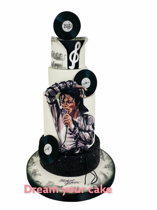 a three tiered cake decorated with vinyl records and an image of michael jackson on it