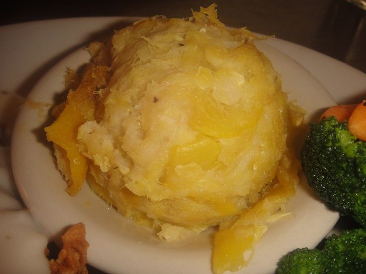 a white plate topped with mashed potatoes and broccoli