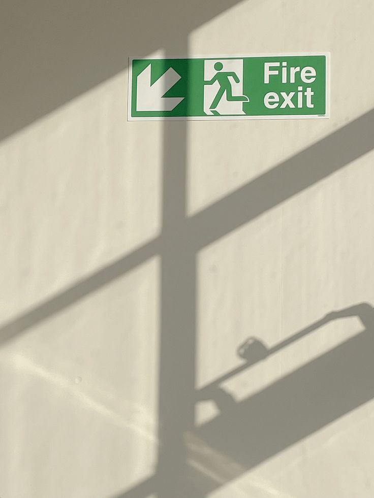 there is a fire exit sign on the wall