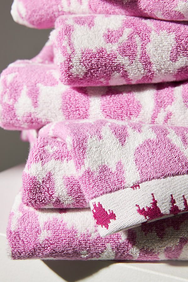 pink and white towels stacked on top of each other in the shape of hearts,