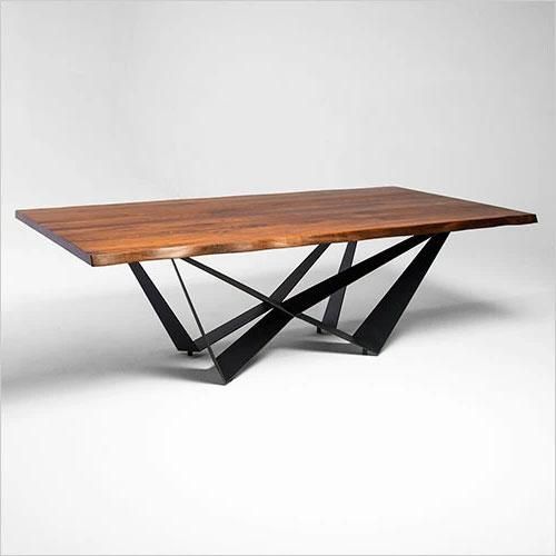 a wooden table with black metal legs and a wood top that has an x design on it