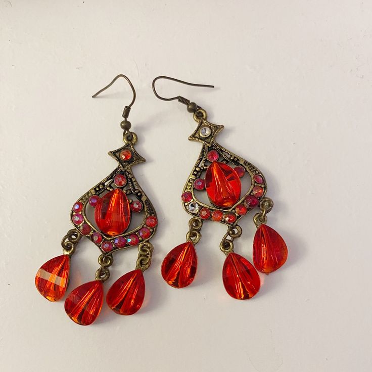 Red Earrings New Use Never Worn Before If Interested Red Crystal Metal Earrings For Parties, Red Crystal Metal Party Earrings, Red Metal Crystal Party Earrings, Red Chandelier Earrings For Party, Red Vintage Dangle Chandelier Earrings, Vintage Red Dangle Chandelier Earrings, Red Teardrop Chandelier Earrings With Ear Wire, Red Vintage Chandelier Dangle Earrings, Red Teardrop Chandelier Earrings