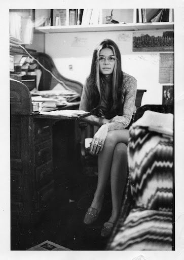 black and white photograph of a woman sitting at her desk