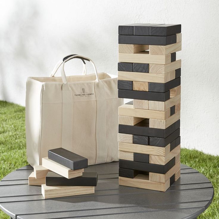 a bag sitting on top of a wooden block tower