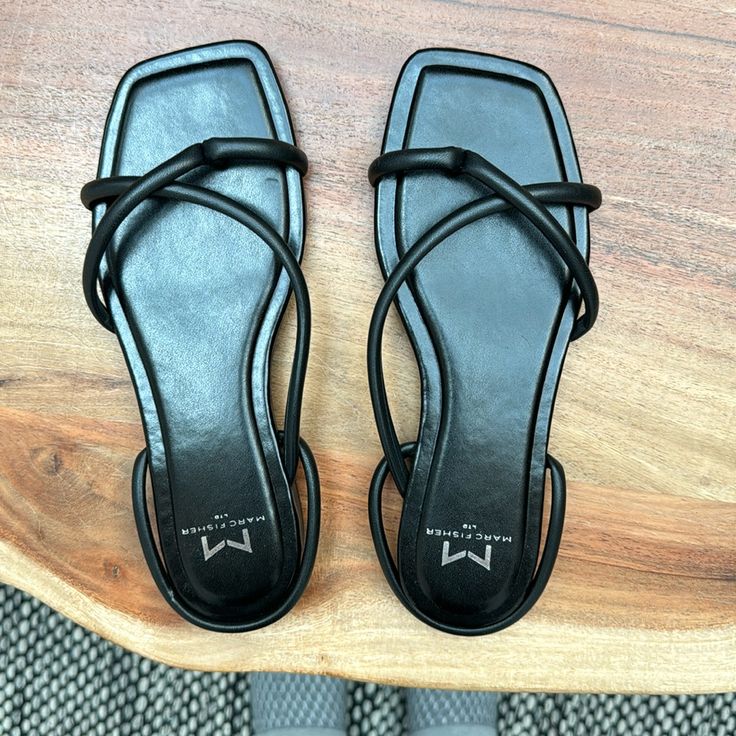 Never Worn Black Flat Sandals With Heel Strap, Black Slingback Sandals With Cushioned Footbed And Open Heel, Black Open Toe Synthetic Slingback Sandals, Black Spring Sandals With Single Toe Strap, Black Flat Synthetic Slingback Sandals, Black Open Toe Slingback Sandals, Black Sandals With Single Toe Strap For Spring, Black Slingback Sandals With Cushioned Footbed For Spring, Trendy Black Flat Heel Slingback Sandals