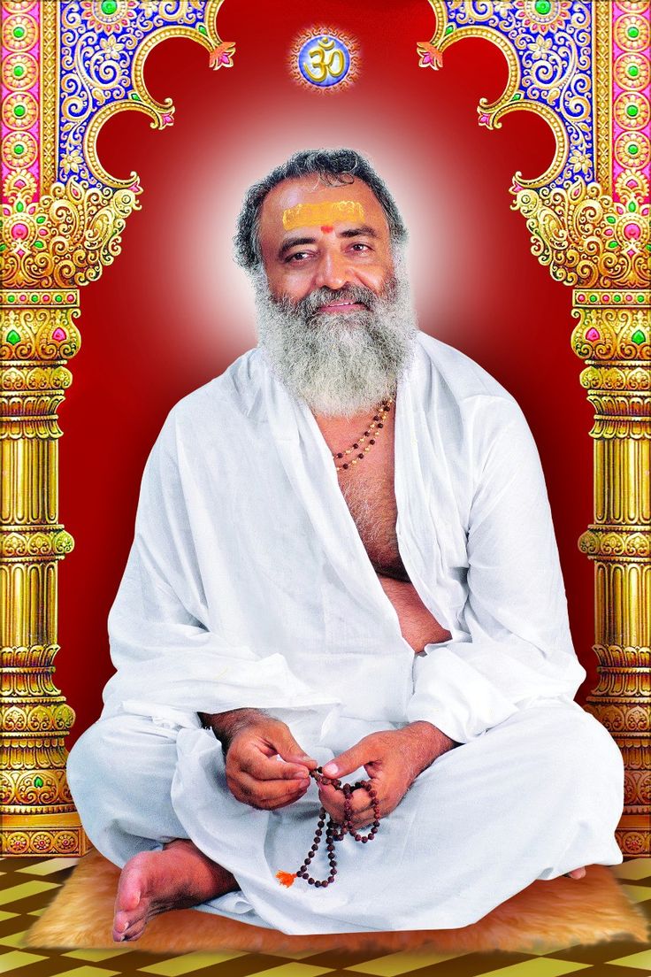 an old man with a long white beard sitting in front of a red and gold wall