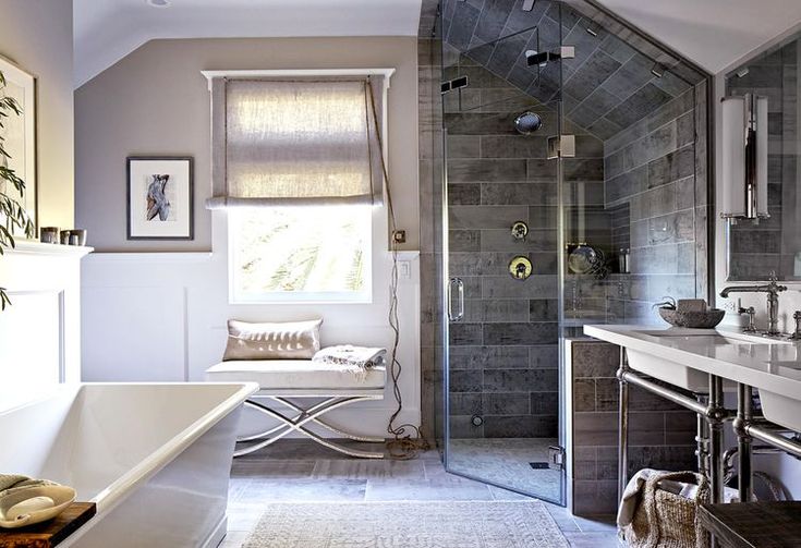 a bathroom with a tub, sink and shower