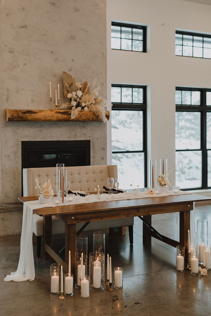 Dried florals, glass votives with candles and a tan color palette accompany a wooden sweetheart table. Neutral Sweetheart Table, Head Table Candles, Sweetheart Table Candles, Rustic Sweetheart Table, Wedding Sweetheart Table Decor, Wedding Couple Table, Minimal Wedding Decor, Head Table Wedding Decorations, Candles Photo