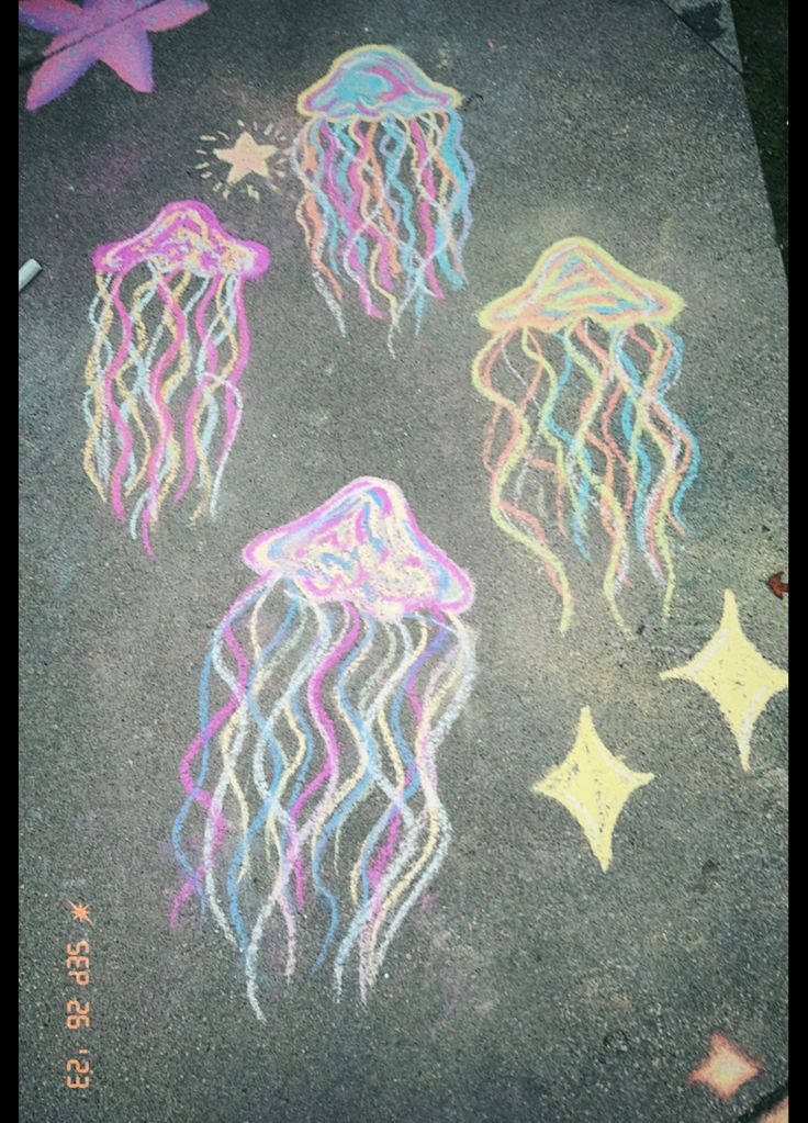 chalk drawing of jellyfishs and stars on the sidewalk