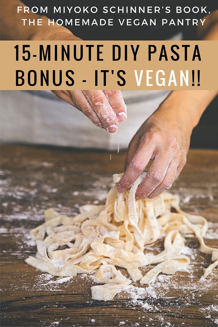 a person is sprinkling pasta with flour on a wooden table