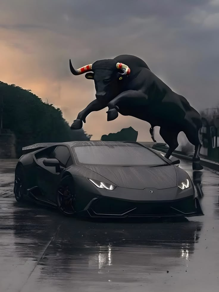 a car with a bull statue on top of it's hood in the rain