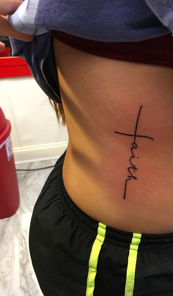 a woman with a cross tattoo on her stomach