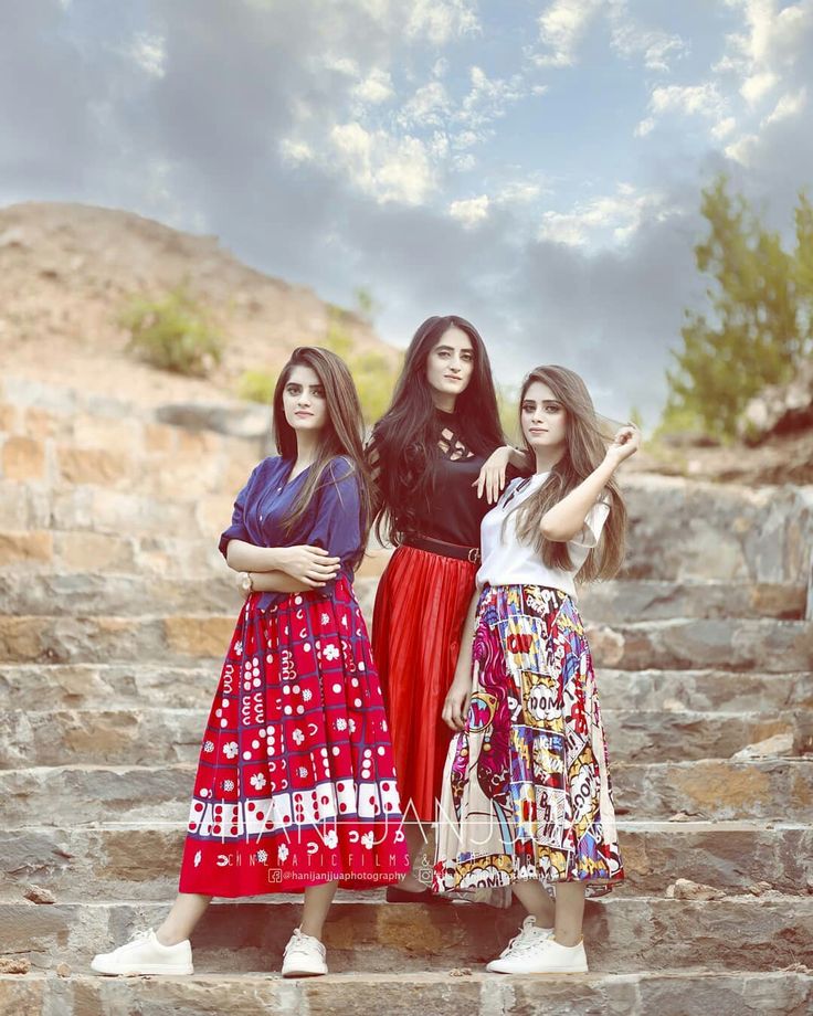 three women standing on some steps with their arms around each other