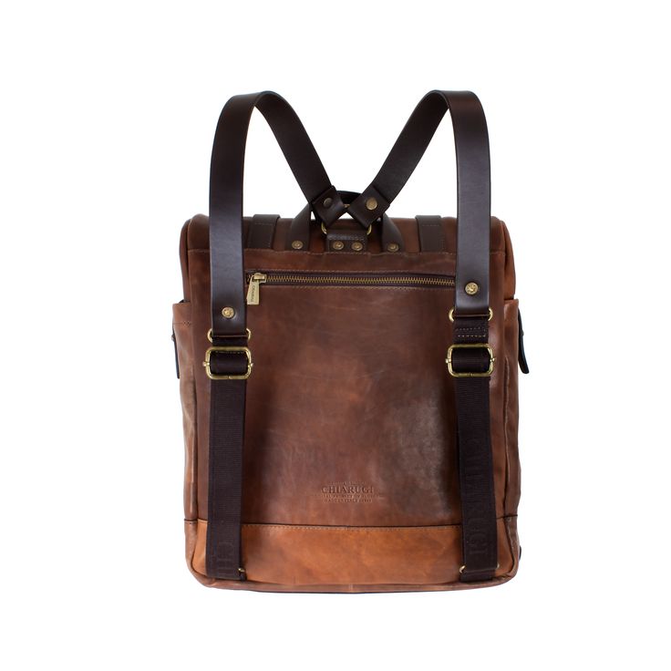 This backpack is practical and stylish, with security pockets, hidden closures, a grab handle on top, and two comfortable, adjustable back/shoulder straps. Use it for both travel and work with ease. Handcrafted of full-grain Italian calfskin in luxurious vegetable-tanned leather and crafted into stunning rustic bags and accessories that develop an enhanced patina with age. Made in Italy, each piece is finished with durable gingham linings and metal hardware. Dimensions: 14 x 12.5 x 5.5" WARNING: Luxury Leather Backpack With Leather Trim For Travel, Modern Brown Leather Backpack With Leather Trim, Brown Leather Backpack With Leather Trim For Everyday Carry, Rugged Leather Satchel Backpack For Travel, Modern Brown Leather Backpack For Everyday Carry, Modern Brown Leather Backpack For Everyday, Rugged Leather Travel Backpack, Luxury Brown Leather Backpack For Trips, Luxury Brown Leather Backpack For Travel