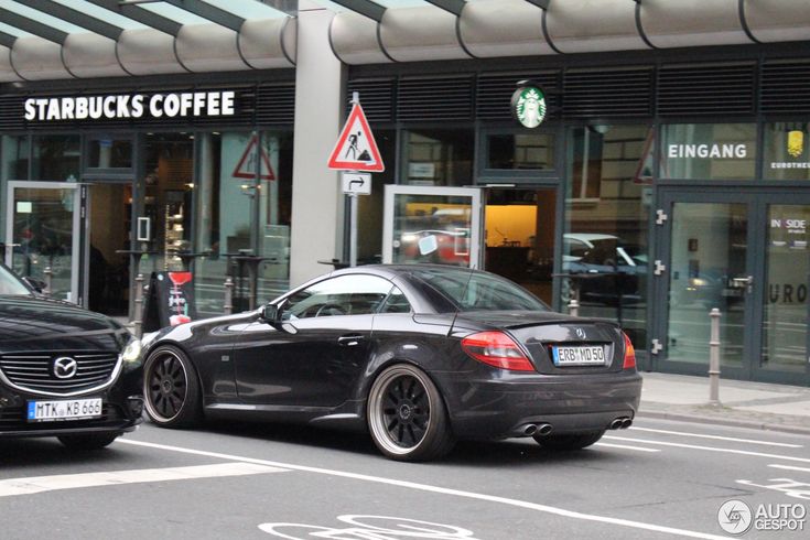 two cars parked in front of starbucks coffee