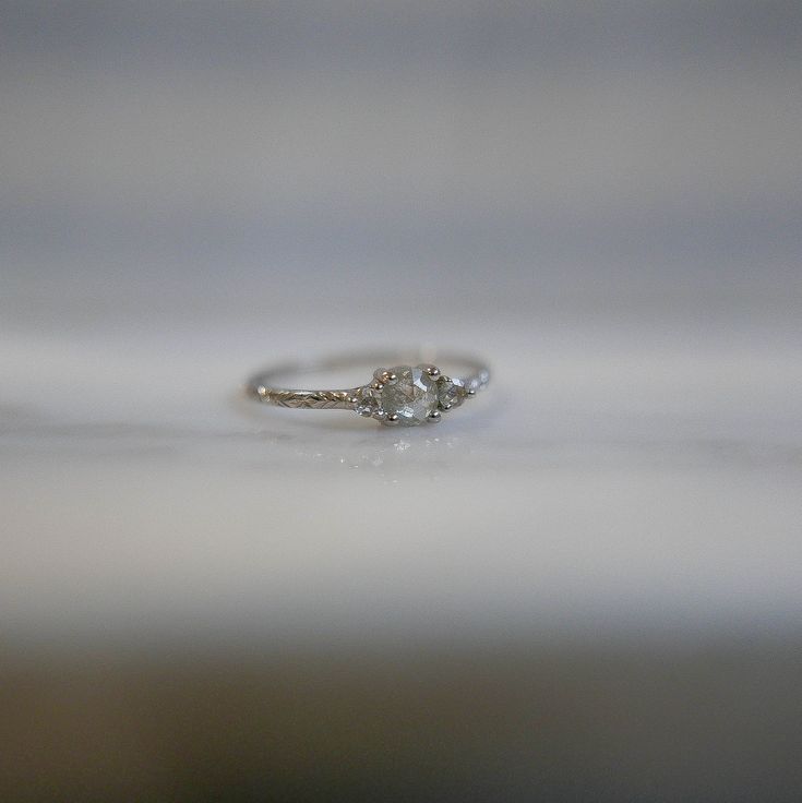 a diamond ring sitting on top of a table