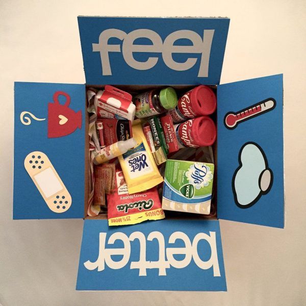 a cardboard box filled with food and candy next to a sticker that says feed