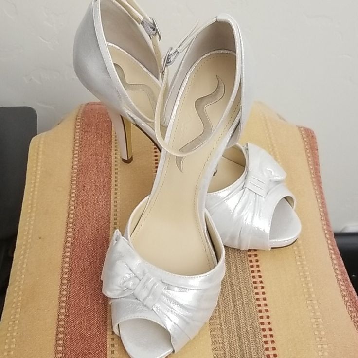 Wedding Ready! These Silver Beauties Have An Ankle Strap And Peep Toe. The Heel Is 4.5 Inches With .5 Inch Platform. They Are Made Of Reflective Fabric And Have Leather Soles. Never Been Worn. Silver Fitted Wedding Shoes With Ankle Strap, Fitted Silver Wedding Shoes With Ankle Strap, Silver Fitted Ankle Strap Wedding Shoes, Silver Heels With 4-inch Heel And Round Toe, Silver Wedding Shoes With 4-inch Heel And Ankle Strap, Elegant Silver Slingback Pumps With 4-inch Heel, Silver Open Toe Slingback Pumps With 4-inch Heel, Evening Heels, Glitter High Heels