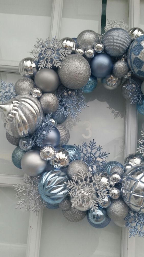 a christmas wreath with silver and blue ornaments