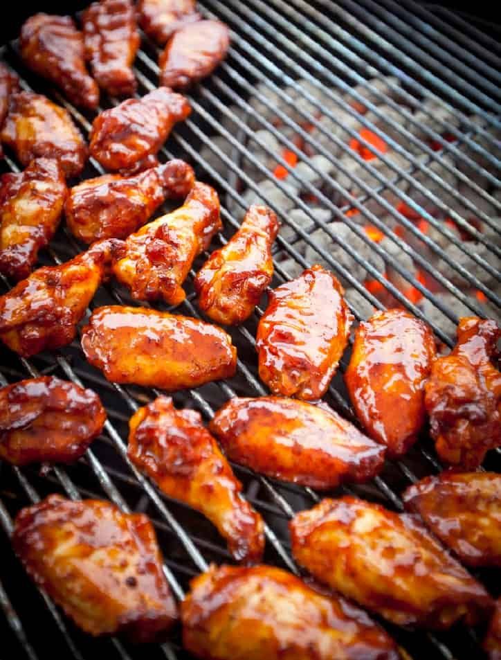 chicken wings are being cooked on the grill