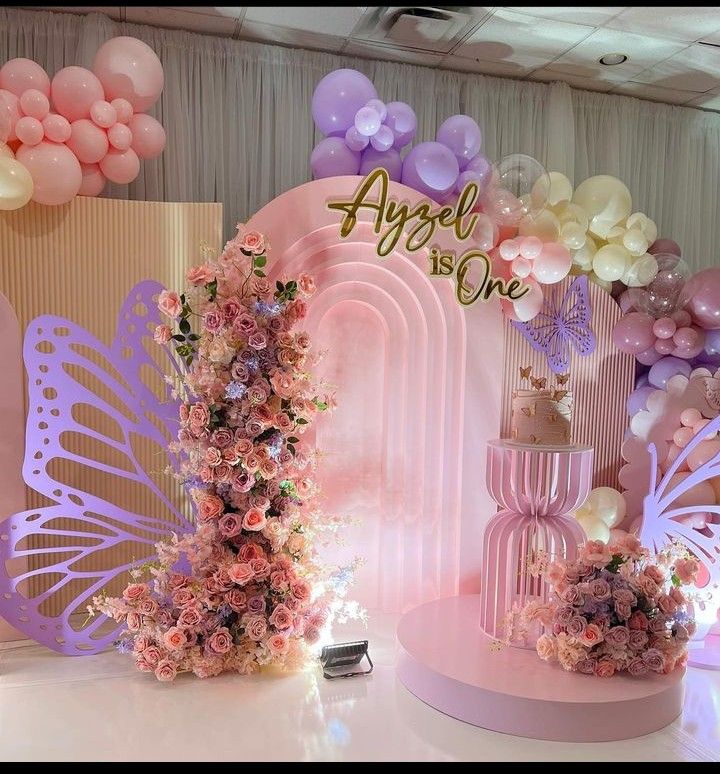 there are many balloons and flowers on the stage for this birthday party at aspreh one