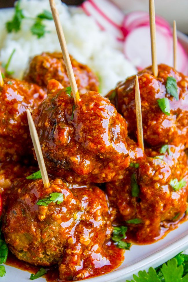 meatballs with sauce and toothpicks on a plate