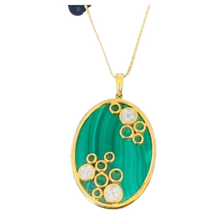 Vintage 14k Gold Malachite and Diamond Pendant This unique malachite pendant made in the 1980s is the perfect statement necklace: bright, bold and sparkly. The three clusters of white diamonds add an extra dazzle to this eye-catching piece and this one-of-a-kind pendant comes on an 18k gold chain! Vintage from the 1980s Necklace length: 18 Inches Materials: 14K Yellow Gold Gemstone: Malachite & Diamond 1980s Necklace, Vintage Silver Brooch, Tiger Pendant, Malachite Necklace, Horse Pendant, Malachite Pendant, 18k Gold Chain, Horses Pendant, Unusual Jewelry