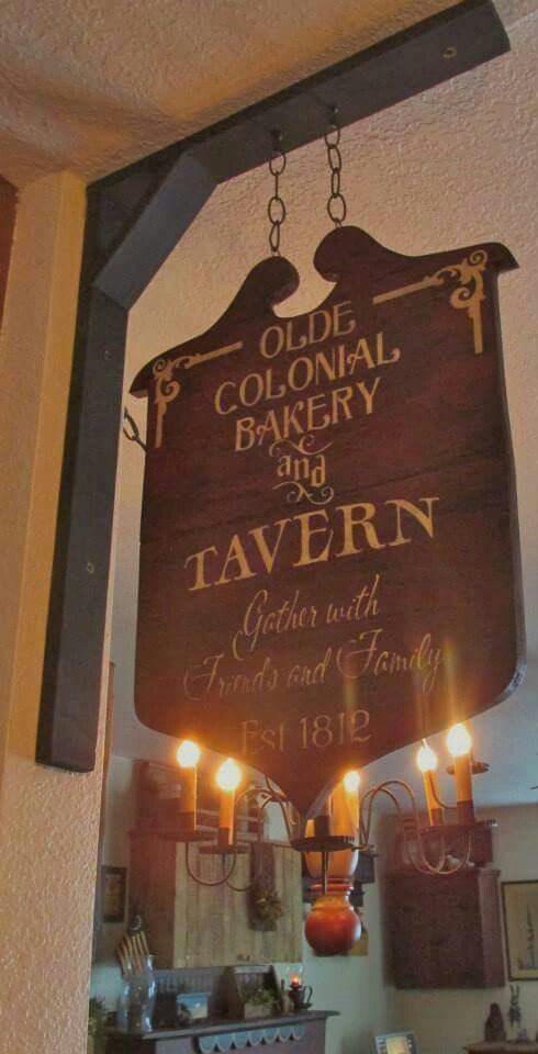 an old colonial bakery and tavern sign hanging from the ceiling