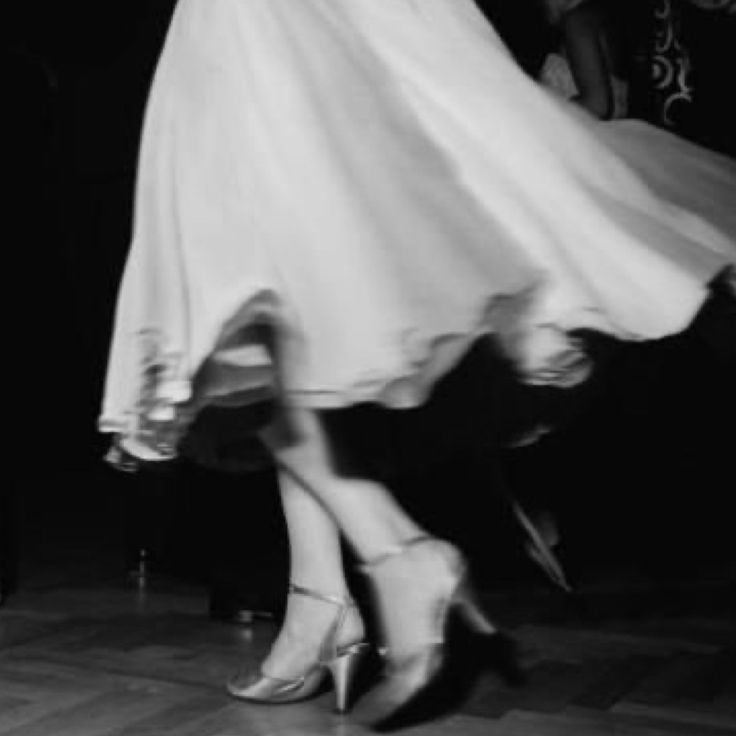 a woman in high heels is dancing on the dance floor