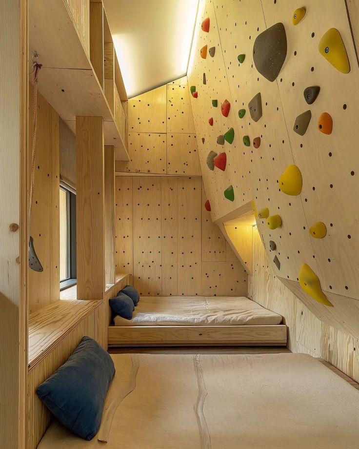 a bedroom with climbing walls and bunk beds