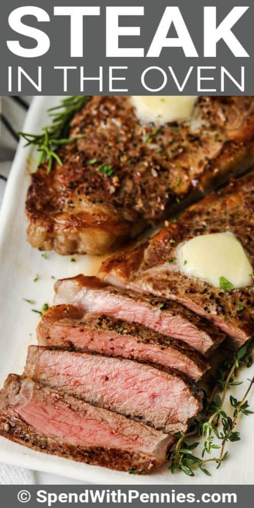 steak in the oven on a white plate with herbs