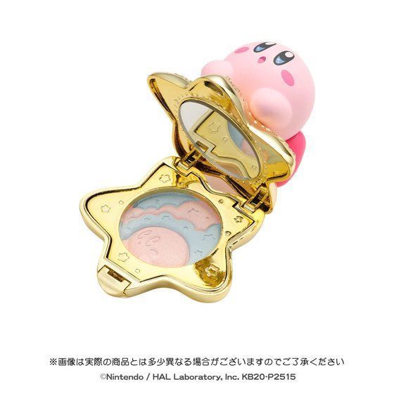 a pink pig sitting on top of a gold compact case with its lid open and eyes closed