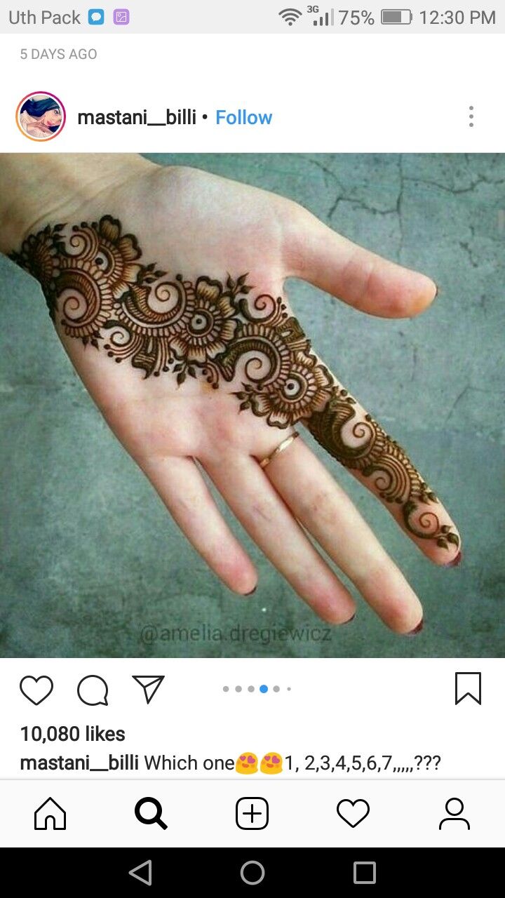 someone is holding their hand with henna on it