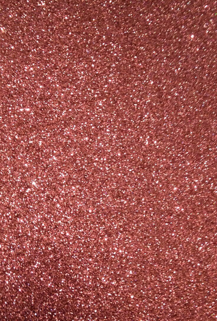 a close up view of a red glitter background