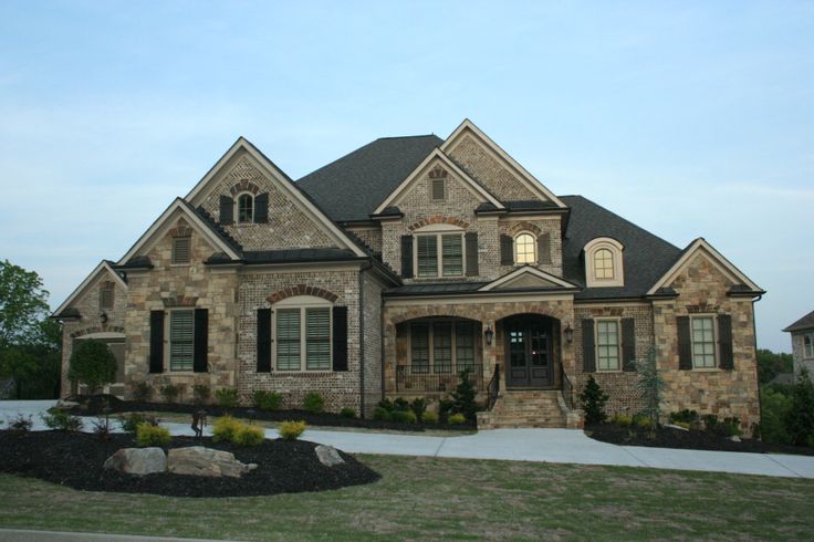 a large brick house with lots of windows