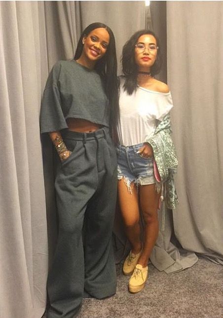 two young women standing next to each other in front of curtained walls and drapes